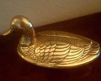 Brass duck and other home decor items.