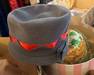 grey hat with red ribbon trim