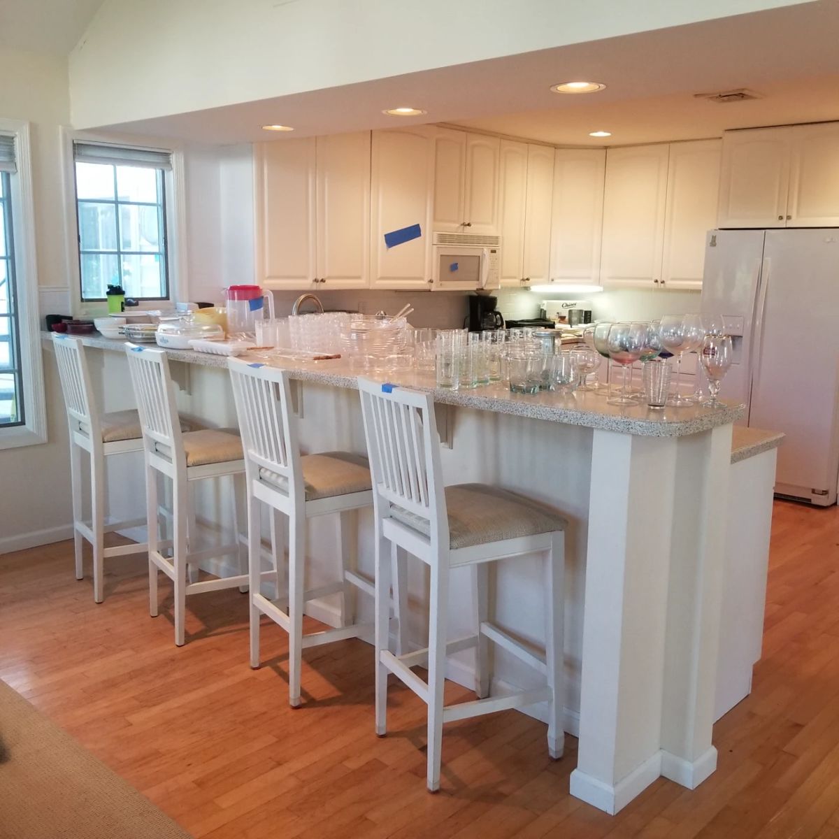 Pretty white kitchen with peninsula; 4 bar stools