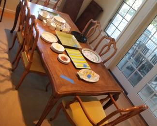 Handsome dining table seats 6; shown with one leaf installed; includes 2 extra leaves