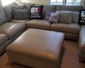 Gorgeous gray leather sectional couch with matching storage ottoman
