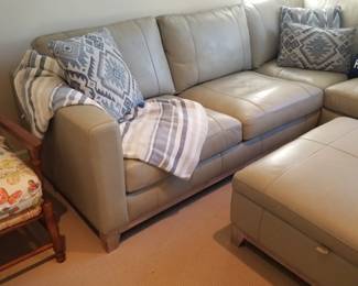 Gorgeous gray leather sectional couch with matching storage ottoman