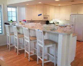 Pretty white kitchen with peninsula; 4 bar stools