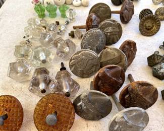 Many many old pulls including the profiles of native americans, peruvian men, other soldiers on door pulls. Note the glass pulls in green and clear glass and amber.