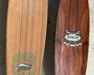 These two skateboards are vintage and beautiful wood pieces.