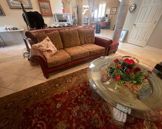 leather and fabric sofa   area rugs- several coffee tables  
