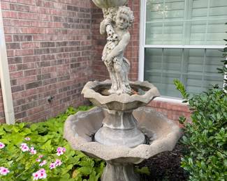 Concrete cherub birdbath