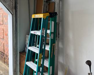 Two fiberglass step ladders and one aluminum one