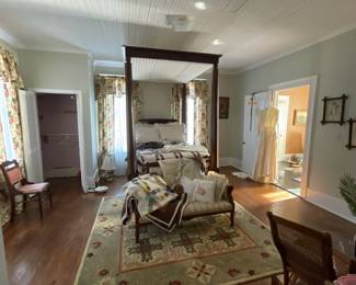 Antique canopy bed; area rugs; quilts; vintage wedding dress