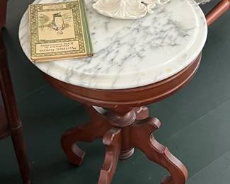 Marble-top round table; Mother Goose book