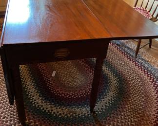 Antique drop leaf Table. Several braided rugs