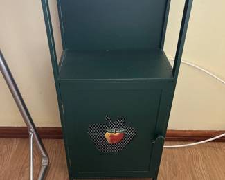 Green Cabinet featuring an apple shaped cutout with mesh. 