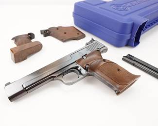 Make: Smith & Wesson
Model: 41
Caliber: .22 LR
Action: Semi
Barrel: 5.5
Bore: Shiny
Serial # 75184
Condition: Very Good
The Smith & Wesson 41 offers reliable performance in a lightweight and durable handgun design. It comes chambered in 22LR with a 5.5 inch barrel. Features include a manual safety, adjustable sights, and a 10 round magazine. This firearm is in its original case, Two extra mags and extra grips. This pistol is in very good condition.