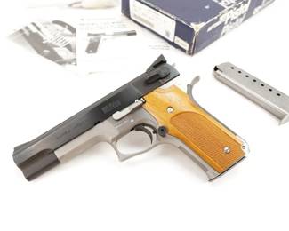 Make: Smith & Wesson
Model: 745 IPSC 10th Anniv. Com.
Caliber: 45 Auto
Action: Semi
Barrel: 5
Bore: Bright
Serial # DVC0481
Condition: Excellent
This Two Tone Smith & Wesson 10th Anniversary 1976-1986 International Practical Shooting Confederation commemorative makes for a great addition to any collection. Chambered in .45 Auto and features a 5” barrel. The right side of the slide is marked with a gold filled IPSC Crest and “10th Anniversary / 1976 – 1986”. The right side of the frame has a small S&W logo. The bottom of the mag-well is marked “T” and “7”. The barrel is marked “45 AUTO” as seen through the ejection port. The left side of the slide is marked “SMITH & WESSON” and has the four line Marcas Registradas address. The left side of the frame is marked “DVC0481 / Model 745”. This 2nd Generation 745 is sold with the factory box and 2 Mags. This Pistol remains in Excellent condition showing normal signs of use and wear. 