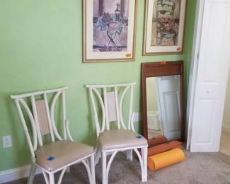 Elegant rattan accent chairs; artwork