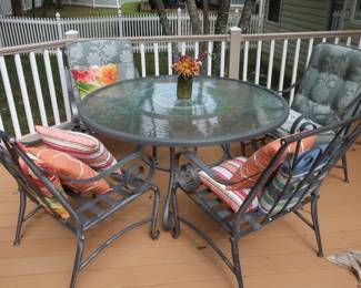 patio  table  and  4  chairs-  needs  cushions  Size  is  53".