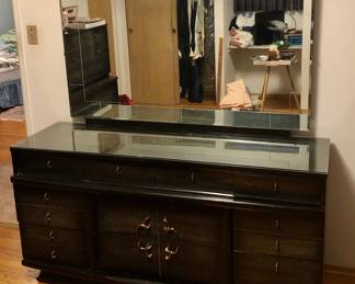 The Black 5 piece (Plus mirror) Bedroom Set $300 4 pieces have glass tops. The tall chest of drawers is 38 inches long by 20 inches deep 48 inches tall.
The Black Long Dresser is 64 inches long 20 inches deep. The base is 33 inches tall. The mirror is 56 inches long. I’m 33 1/2 inches tall. There is a corner of the glass broken.
The 2 Nightstands are 22 inches long 15 1/2 inches deep and 26 inches tall.
The Black Headboard and Footboard are 58 inches long 10 inches deep and 38 1/2 inches tall. $300