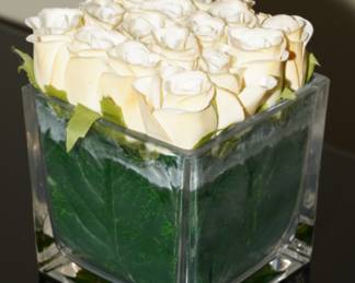 Faux roses in square glass vase