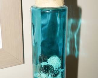 Blue glass vase with seashells