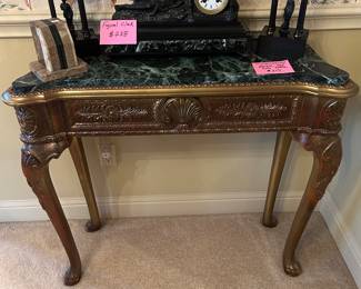 Marble top console table, bronze clock and bookends