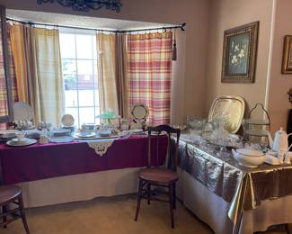In the dining room you will find these tables with beautiful vintage Lenox china, depression glass and silver plate