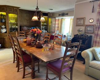 Another view of the table and showing 6 ladder back chairs with upholstered seats that go with the table