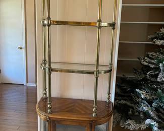 Vintage brass display with glass shelves and a lower storage cupboard
