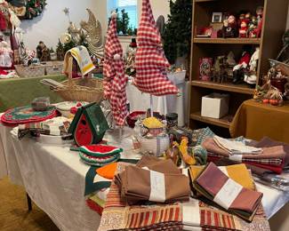Looking at the linen table with three red and white fabric Christmas Trees