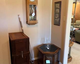 Entryway with antique oak drawers, vintage six sided accent table with storage, vintage wall clock, walking sticks