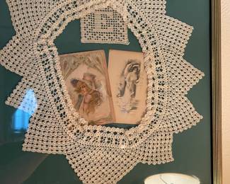 A close look at one of the framed doily pieces, this one has vintage postcards