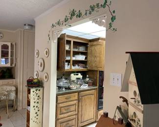 Another look into the kitchen. Tall shelf with painted ivy design
