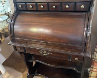 A vintage small roll top desk