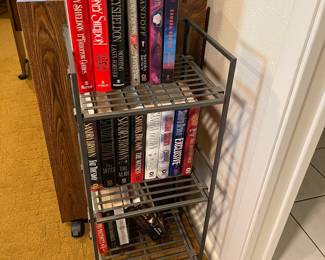 Metal shelf, hard back and soft back novels