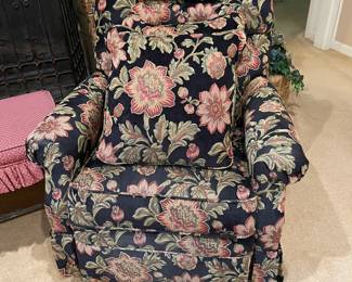 Upholstered rocking recliner with cushions