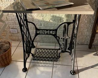 Vintage Singer sewing machine base with a marble and glass tops