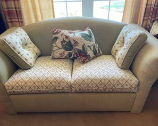 Love seat with matching palm tree cushions