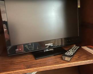 Small flat screen TV made by Insignia with remote
