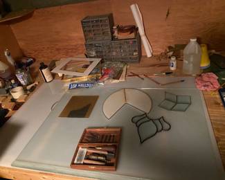 Stained glass studio with all of the tools and loads of colored glass.