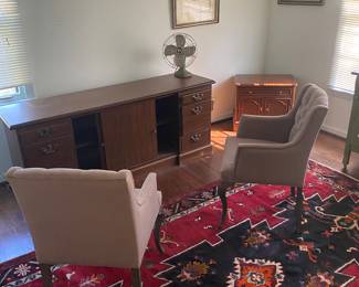 Office with desk, cute chairs, and amazing rug.