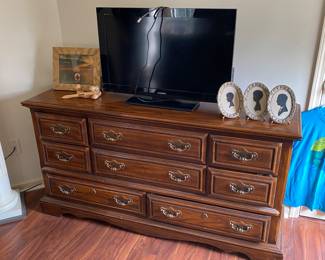 Stout dresser adorned with TV and cameos. Word Up!
