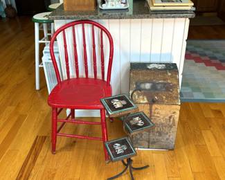 Plant stand with elephant tiles, red chair, pr of stools in background right. Etc.