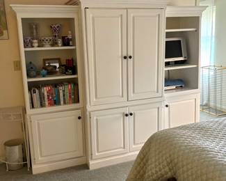 Lg white cabinets. Books. Bed linens.