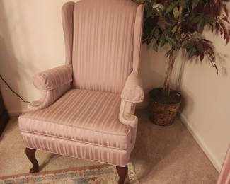 One of two pink wing back chairs.