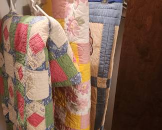 Three quilts, one or two appear hand sewn.