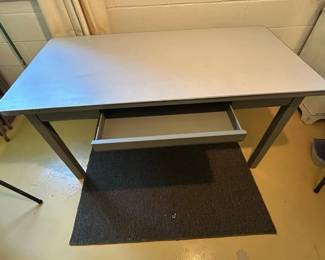 Heavy metal one drawer table with formica top. This would be great for a kitchen work table