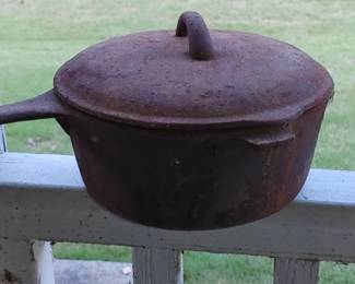 Early cast iron Dutch oven needs cleaning
