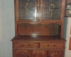 Beautiful Oak Kitchen table with hide-away leaf. Set includes 6 matching chairs and matching hutch with stained glass inserts. Hutch has 2 cabinet doors and 2 drawers. Hutch 78T x 48W x 18.5 D Table 48 Round 72 Oval.