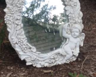Whimsical double cherub mirror. Used as a focal point along a garden path.