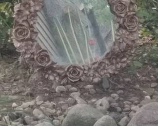 Round cherub mirror. Used as a focal point in the garden.