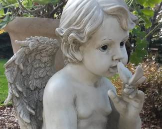 Cherub with butterfly garden statue.